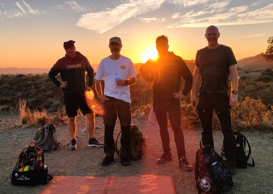 Four disc golf players at sunset on the course in Mijas